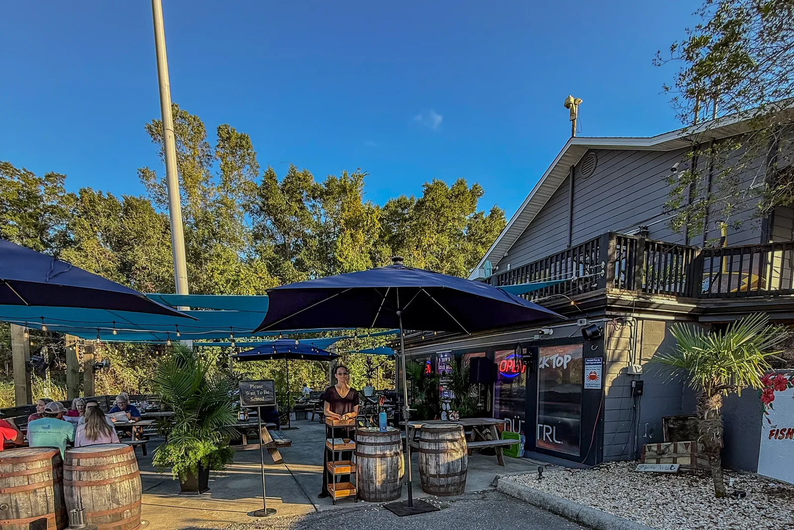 Outdoor patio at The Fishing Hole Hideout, the on-site restaurant at Swamp House in Pensacola, FL