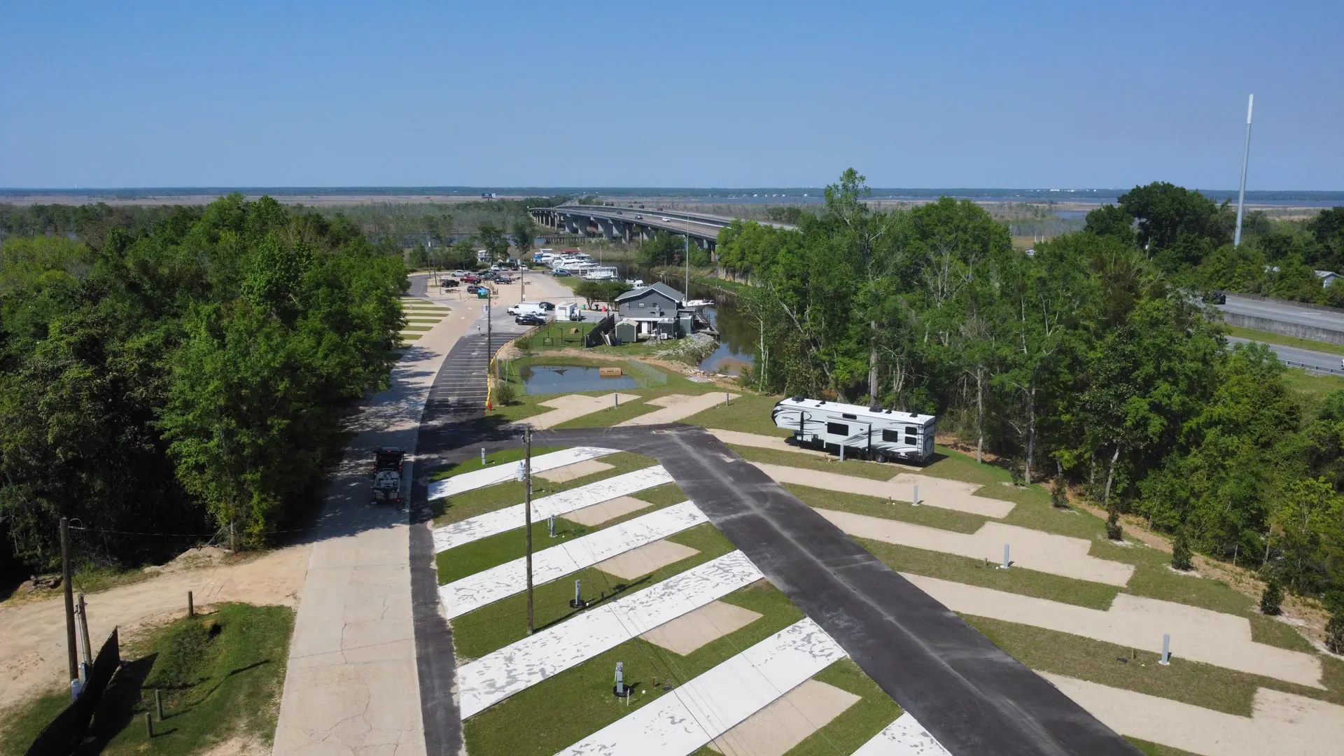 Aerial view of Swamp House RV Park & Marina in Pensacola, FL, with full-hookup RV sites in front and the marina and bayou behind them
